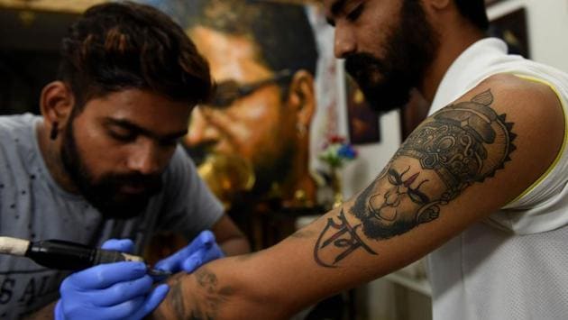 A customer braves his second tattoo at The Mustcahe Tattoo Studio in Kopar Khairane. (Bachchan Kumar /HT PHOTO)