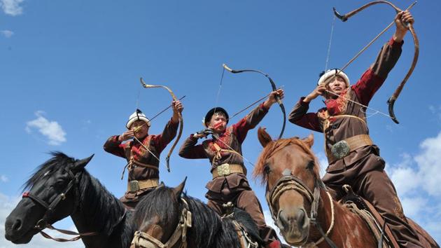 Kyrgyz men in traditional attire pose on horseback as they prepare to shoot arrows during the 'Ethno Fest' festival in the village of Ton, Kyrgyzstan. (Vyacheslav Oseledko / AFP) Kyrgyz men in traditional attire pose on horseback as they prepare to shoot arrows during the 'Ethno Fest' festival in the village of Ton, Kyrgyzstan. (Vyacheslav Oseledko / AFP)