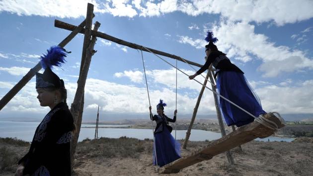 Kyrgyz women wearing traditional clothes enjoy a ride on a swing during the 'Ethno Fest' festival. (Vyacheslav Oseledko / AFP) Kyrgyz women wearing traditional clothes enjoy a ride on a swing during the 'Ethno Fest' festival. (Vyacheslav Oseledko / AFP)