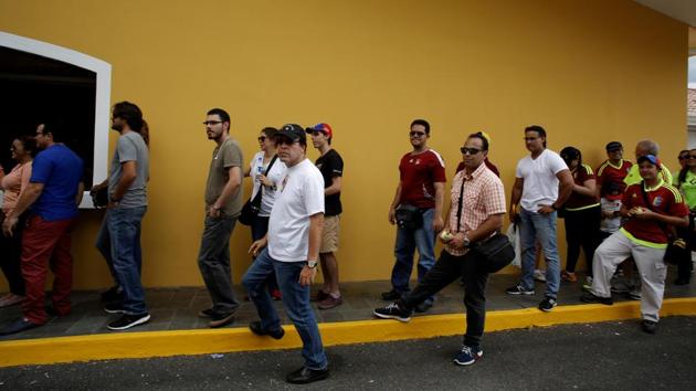 People wait to cast their votes in San Jose, Costa Rica. The balloting was organized by the opposition and denounced by the government as illegal and seditious. But turnout appeared high at thousands of makeshift voting places set up throughout the country (Juan Carlos Ulate / REUTERS) People wait to cast their votes in San Jose, Costa Rica. The balloting was organized by the opposition and denounced by the government as illegal and seditious. But turnout appeared high at thousands of makeshift voting places set up throughout the country (Juan Carlos Ulate / REUTERS)