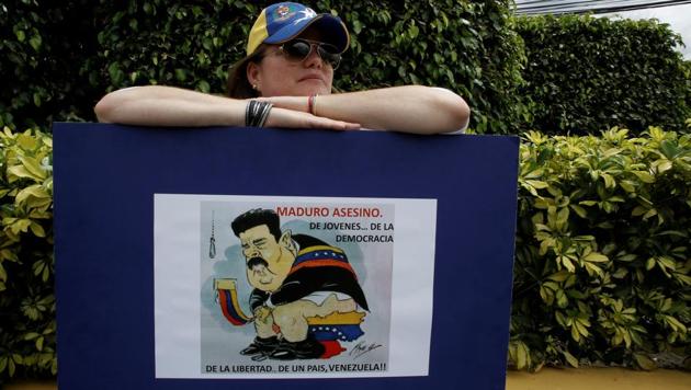 A woman holds a sign during an unofficial plebiscite against Venezuela President Nicolas Maduro's government, in San Jose, Costa Rica. Government opponents sought to deal a symbolic blow to Venezuelan President Nicolas Maduro, casting votes in an unofficial referendum designed to reject his controversial plan for a constitutional overhaul. More than 7.1 million people voted in a symbolic rejection of President Nicolas Maduro’s plan to rewrite the constitution. (Juan Carlos Ulate / REUTER) A woman holds a sign during an unofficial plebiscite against Venezuela President Nicolas Maduro's government, in San Jose, Costa Rica. Government opponents sought to deal a symbolic blow to Venezuelan President Nicolas Maduro, casting votes in an unofficial referendum designed to reject his controversial plan for a constitutional overhaul. More than 7.1 million people voted in a symbolic rejection of President Nicolas Maduro’s plan to rewrite the constitution. (Juan Carlos Ulate / REUTER)