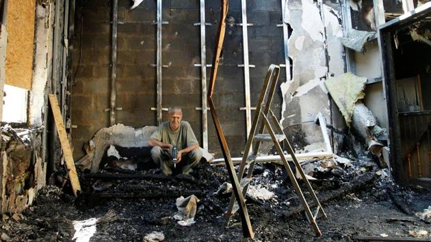 A resident sits in his house, which was damaged by shelling, in the rebel-controlled city of Donetsk, Ukraine. (Reuters Photo) A resident sits in his house, which was damaged by shelling, in the rebel-controlled city of Donetsk, Ukraine. (Reuters Photo)