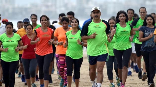 Participants practice for the Hindustan Times Monsoon marathon at Juhu in Mumbai. (Satish Bate/HT Photo)
