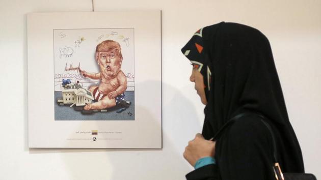 An Iranian woman looks at a cartoon of US President Donald Trump at an exhibition in capital Tehran earlier this month.(AFP Photo) An Iranian woman looks at a cartoon of US President Donald Trump at an exhibition in capital Tehran earlier this month.(AFP Photo)