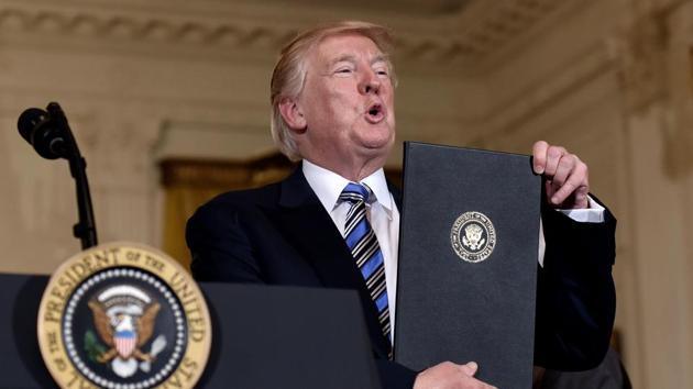 File photo of US President Donald Trump holding a signed proclamation designating July 17 the "Made in America Day." (AFP) File photo of US President Donald Trump holding a signed proclamation designating July 17 the "Made in America Day." (AFP)