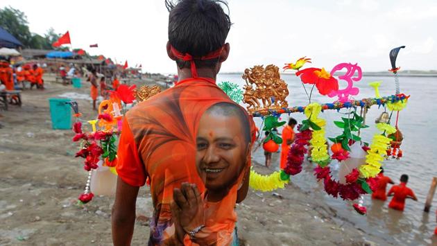 A kanwariya, wearing shirt with Yogi Adityanath’s picture is seen on the bank of river Ganga in Allahabad. (Jitendra Prakash / REUTERS)
