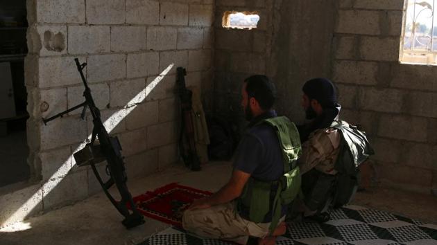 Free Syrian Army fighters pray inside a house in rebel-held Al-Yadudah village, in Deraa Governorate, Syria on Wednesday. (REUTERS) Free Syrian Army fighters pray inside a house in rebel-held Al-Yadudah village, in Deraa Governorate, Syria on Wednesday. (REUTERS)