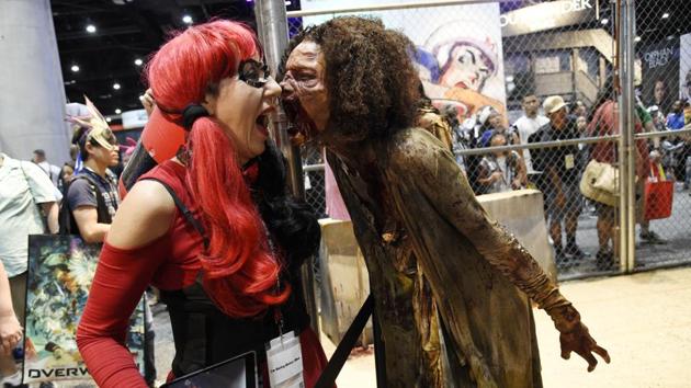 Judy Hawkins, left, of San Diego, reacts as a zombie character approaches her at the Walking Dead exhibit on the convention show floor during Preview Night of the 2017 Comic-Con International. (Chris Pizzello/Invision/AP) Judy Hawkins, left, of San Diego, reacts as a zombie character approaches her at the Walking Dead exhibit on the convention show floor during Preview Night of the 2017 Comic-Con International. (Chris Pizzello/Invision/AP)