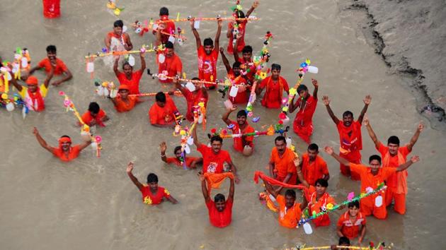 Kanwariyas taking a dip in the Ganga river during holy month of Shravan in Allahabad. (PTI)