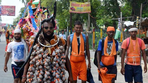 A Shiva devotee walks along with other Kanwariyas during their pilgrimage in Meerut. (PTI Photo)