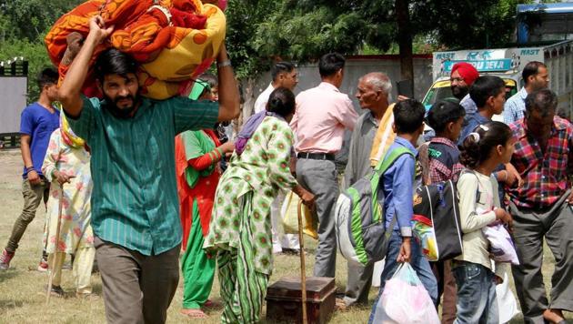 Jammu: Border migrants of Jhanghar village take shelter in government school after shelling from Pakistan side at Nowshera sector of Rajouri district on Sunday. PTI Photo(PTI5_14_2017_000150B) (PTI) Jammu: Border migrants of Jhanghar village take shelter in government school after shelling from Pakistan side at Nowshera sector of Rajouri district on Sunday. PTI Photo(PTI5_14_2017_000150B) (PTI)