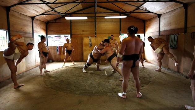 Mongolian-born Tomozuna Oyakata, or master of the Tomozuna stable (L), attends his wrestlers' training session at Ganjoji Yakushido temple in Nagoya, Japan. The temple is used by sumo wrestlers belonging to the Tomozuna stable as a temporary base for the Nagoya Grand Sumo Tournament. (Issei Kato / REUTERS) Mongolian-born Tomozuna Oyakata, or master of the Tomozuna stable (L), attends his wrestlers' training session at Ganjoji Yakushido temple in Nagoya, Japan. The temple is used by sumo wrestlers belonging to the Tomozuna stable as a temporary base for the Nagoya Grand Sumo Tournament. (Issei Kato / REUTERS)