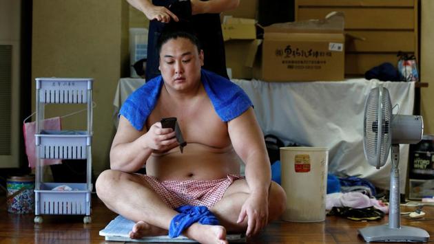 Mongolian-born sumo wrestler Kyokushuho has his hair fixed after a training session. Japan’s remarkably insulated society has always held a distinction between locals and foreigners, extending even to half-japanese born abroad. (Issei Kato / REUTERS) Mongolian-born sumo wrestler Kyokushuho has his hair fixed after a training session. Japan’s remarkably insulated society has always held a distinction between locals and foreigners, extending even to half-japanese born abroad. (Issei Kato / REUTERS)