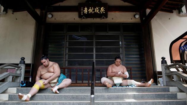 Brazilian-born sumo wrestler Kaisei (L), and Mongolian-born sumo wrestler Kyokushuho tape up during a training session at Ganjoji Yakushido temple in Nagoya, Japan. (Issei Kato / REUTERS) Brazilian-born sumo wrestler Kaisei (L), and Mongolian-born sumo wrestler Kyokushuho tape up during a training session at Ganjoji Yakushido temple in Nagoya, Japan. (Issei Kato / REUTERS)