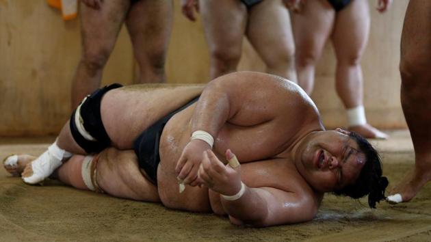 ‘We wear our topknots, kimonos and sandals, and live by Japanese rules, and the rules of sumo,’ said Tomozuna Oyakata. ‘It’s only by chance that we were born a different nationality’. Full assimilation into Japanese culture means that foreign wrestlers face no ill-will. (Issei Kato / REUTERS) ‘We wear our topknots, kimonos and sandals, and live by Japanese rules, and the rules of sumo,’ said Tomozuna Oyakata. ‘It’s only by chance that we were born a different nationality’. Full assimilation into Japanese culture means that foreign wrestlers face no ill-will. (Issei Kato / REUTERS)
