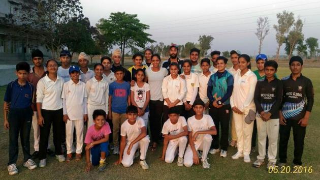 Harmanpreet with her coach Yadwinder Singh Sodhi and young trainees at Moga. (HT PHOTO )