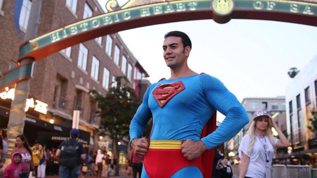 A Cosplay character dressed as Superman, poses for pictures along 5th Avenue in the Gaslamp Quarter. (Sandy Huffaker / AFP)