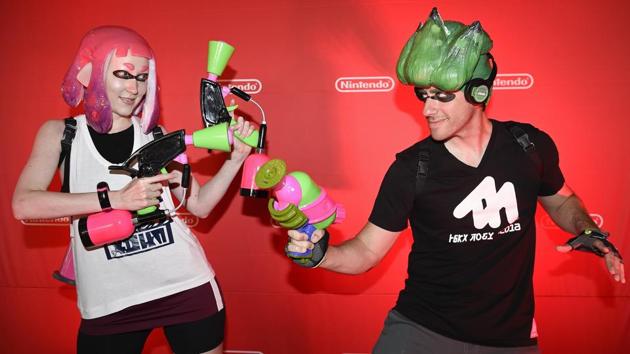 Cosplayers Heidi O'Ferrall and Leo Camacho pose in Splatoon 2-inspired costumes at the Marriott Marquis and Marina outside the Nintendo Summer of Play event. Splatoon 2 launches on July 21 exclusively for the Nintendo Switch system. (Invision for Nintendo)