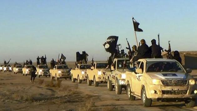 Militants of the Islamic State group hold up their weapons and wave its flags on their vehicles in a convoy on a road leading to Iraq, in Raqqa, Syria. (AP File Photo) Militants of the Islamic State group hold up their weapons and wave its flags on their vehicles in a convoy on a road leading to Iraq, in Raqqa, Syria. (AP File Photo)