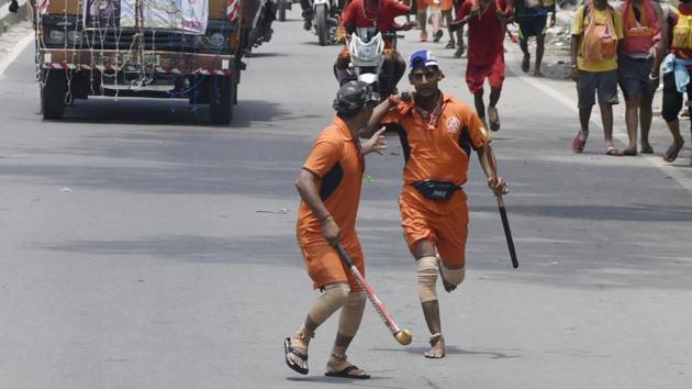 The method of transporting the holy water is left up to the devotee undertaking the task. The journey in older times would only draw saints or the elderly walking to and fro with simple kanwars, but rising popularity since the 1980s has swung demographics towards a younger and more masculine crowd. Kanwariyas may undertake the journey solo, with elaborate kanwars that may not touch the ground or even as a team, using motorcycles and trucks to run relays without a pause in the movement of the Gangajal. (Vipin Kumar / HT Photo) 