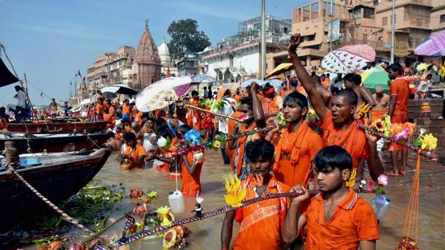 Kanwariyas walk down the steps of the ghats of the Ganga to take a dip in, and collect its water as part of their Yatra in Varanasi, Uttar Pradesh. (PTI) Kanwariyas walk down the steps of the ghats of the Ganga to take a dip in, and collect its water as part of their Yatra in Varanasi, Uttar Pradesh. (PTI)