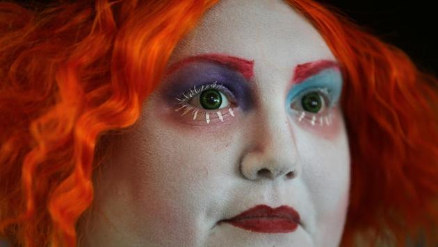 Attendee with red hair and green eyes in costume during opening day of Comic Con. (Mike Blake / REUTERS)
