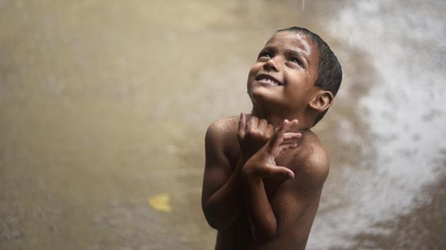 A little boy gazes towards the sky during a heavy shower in the capital New Delhi. (Burhaan Kinu / HT Photo) A little boy gazes towards the sky during a heavy shower in the capital New Delhi. (Burhaan Kinu / HT Photo)