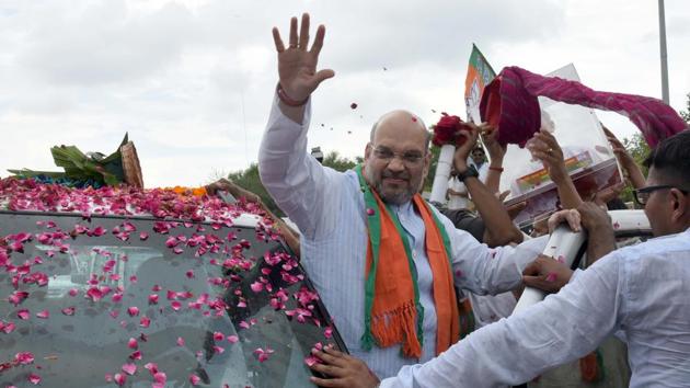 BJP national president Amit Shah waves to supporters as his cavalcade advances from Sanganer airport to the state party office in Jaipur on Friday. (Prabhakar Sharma/ HT Photo) BJP national president Amit Shah waves to supporters as his cavalcade advances from Sanganer airport to the state party office in Jaipur on Friday. (Prabhakar Sharma/ HT Photo)