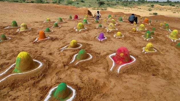 A sand artist creates 'Shivlings', idols symbolic of Lord Shiva in Pushkar, Rajasthan. (PTI) A sand artist creates 'Shivlings', idols symbolic of Lord Shiva in Pushkar, Rajasthan. (PTI)