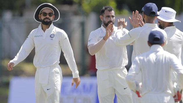 Virat Kohli, left, smiles as his teammates congratulate Mohammed Shami ,second left, for taking a wicket during a warm up game against Sri Lanka's Board XI. (AP) Virat Kohli, left, smiles as his teammates congratulate Mohammed Shami ,second left, for taking a wicket during a warm up game against Sri Lanka's Board XI. (AP)