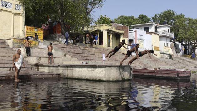 Groups of boys can be seen leaping off the banks of the Yamuna in Delhi, where they hone their skills, diving and treading water. They also row boats which are then used to launch into tricks before they hit the water.   (Saumya Khandelwal / HT Photo) 
