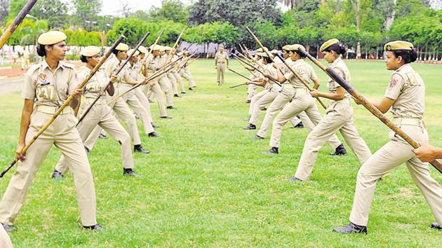 Female cadets showing their combative skills with ‘lathis’. (Bharat Bhushan/HT )