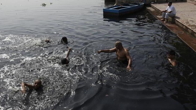 The kids have grown up hearing stories of a Yamuna that once ran clear, and was frequented by tourists to New Delhi. As they dive in today, murky, waste laden water and a river in frail health is all that greets them.  (Saumya Khandelwal / HT Photo) 