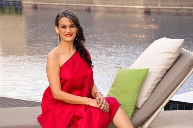 Designer Anu PD , 50, started modelling a few years ago to spread awareness for social causes. She is raising her style stakes in a one-shouldered  wine coloured dress by Payal Khandwala. She has spruced up her look with cherry red lips. ( Styling: Shara Ashraf) (HT Photo/ Shara Ashraf ) 