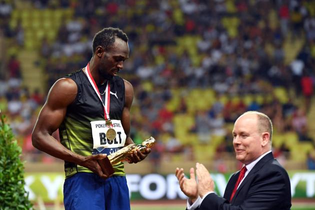 Usain Bolt looks at his trophy whilst flanked by Prince Albert II of Monaco. (AFP) Usain Bolt looks at his trophy whilst flanked by Prince Albert II of Monaco. (AFP)