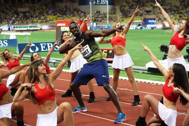 Usain Bolt also struck up the pose alongside some pom-pom girls. (AFP) Usain Bolt also struck up the pose alongside some pom-pom girls. (AFP)