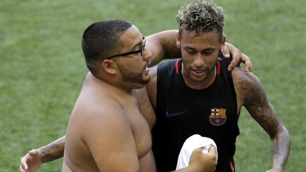A fan embraces Barcelona's Neymar at the end of a training session ahead of an International Champions Cup football match against Juventus on Friday in New Jersey.(AP)