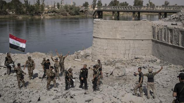 Iraqi Special Forces soldiers celebrate after reaching the bank of the Tigris river as their fight against Islamic State militants continues in parts of the Old City of Mosul, Iraq, on July 9.(AP File Photo) Iraqi Special Forces soldiers celebrate after reaching the bank of the Tigris river as their fight against Islamic State militants continues in parts of the Old City of Mosul, Iraq, on July 9.(AP File Photo)