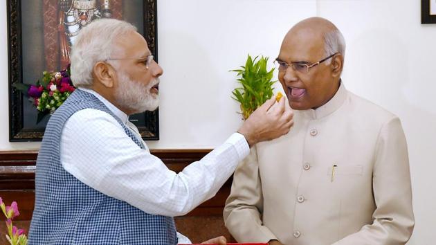 Prime Minister Narendra Modi offers sweet to Ram Nath Kovind on being elected as the 14th President of India, in New Delhi on Thursday.(PTI Photo)