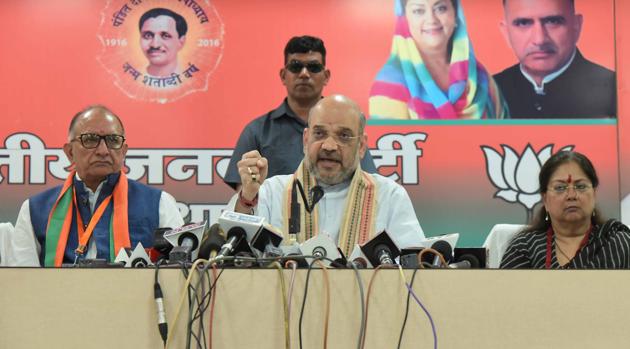 BJP president Amit Shah (Centre) and Rajasthan chief minister Vasundhara Raje (right) interacting with party leaders in Jaipur on Saturday. (Prabhakar Sharma/HT Photo.) BJP president Amit Shah (Centre) and Rajasthan chief minister Vasundhara Raje (right) interacting with party leaders in Jaipur on Saturday. (Prabhakar Sharma/HT Photo.)