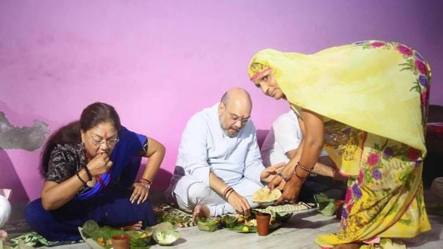 BJP president Amit Shah has lunch at a Dalit family's home along with CM Vasundhara Raje, in Jaipur on Sunday. (Himanshu Vyas/HT Photo) BJP president Amit Shah has lunch at a Dalit family's home along with CM Vasundhara Raje, in Jaipur on Sunday. (Himanshu Vyas/HT Photo)