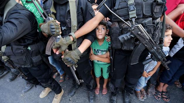 Palestinian boys stand next to Hamas militants as they take part in a military show against Israel's newly-installed security measures at the entrance to the al-Aqsa mosque compound, in Khan Younis, in the southern Gaza Strip. (Ibraheem Abu Mustafa / REUTERS) Palestinian boys stand next to Hamas militants as they take part in a military show against Israel's newly-installed security measures at the entrance to the al-Aqsa mosque compound, in Khan Younis, in the southern Gaza Strip. (Ibraheem Abu Mustafa / REUTERS)
