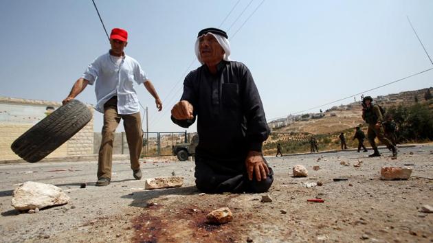 A Palestinian man gestures at the scene where a Palestinian who attempted to stab Israeli soldiers was shot dead by Israeli troops in the West Bank village of Tuqu near Bethlehem. (Mussa Qawasma / REUTERS) A Palestinian man gestures at the scene where a Palestinian who attempted to stab Israeli soldiers was shot dead by Israeli troops in the West Bank village of Tuqu near Bethlehem. (Mussa Qawasma / REUTERS)