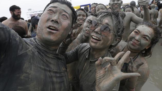 There’s also an open-air disco, Miss Mud beauty pageant, mud yoga and sports activities including a relay race and a marathon. (Ahn Young-joon / AP) 