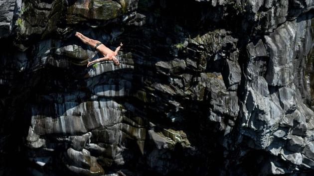 Russian diver Nikita Fedotov competes during the International Cliff Diving Championship in Ponte Brolla, southern Switzerland. Surrounded by steep granite cliffs, the canyon of Ponte Brolla belongs to one of the world's most spectacular natural settings for cliff diving. The natural diving pool has an average water depth of around 13 to 15 meters. (Fabrice COFFRINI /AFP) Russian diver Nikita Fedotov competes during the International Cliff Diving Championship in Ponte Brolla, southern Switzerland. Surrounded by steep granite cliffs, the canyon of Ponte Brolla belongs to one of the world's most spectacular natural settings for cliff diving. The natural diving pool has an average water depth of around 13 to 15 meters. (Fabrice COFFRINI /AFP)