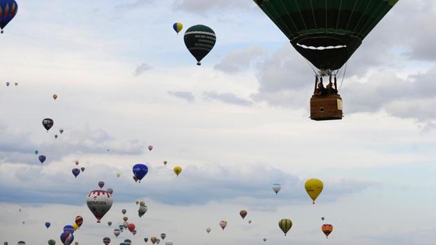 Hot-air balloons fly over Chambley-Bussieres airbase, northeastern France, during the international hot air balloons meeting ‘Mondial Air Ballons’ in Hageville. (JEAN-CHRISTOPHE VERHAEGEN / AFP) Hot-air balloons fly over Chambley-Bussieres airbase, northeastern France, during the international hot air balloons meeting ‘Mondial Air Ballons’ in Hageville. (JEAN-CHRISTOPHE VERHAEGEN / AFP)