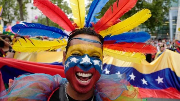 A participant from Venezuela takes part in Berlin's annual Christopher Street Day (CSD) gay pride parade on July 22, 2017. Gays and lesbians all around the World are celebrating the Christopher Street Day (CSD) gay and lesbian pride parade. (John MACDOUGALL / AFP) A participant from Venezuela takes part in Berlin's annual Christopher Street Day (CSD) gay pride parade on July 22, 2017. Gays and lesbians all around the World are celebrating the Christopher Street Day (CSD) gay and lesbian pride parade. (John MACDOUGALL / AFP)