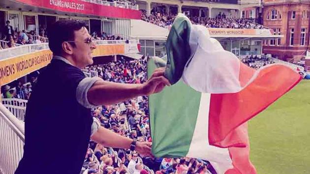 Akshay Kumar waves the national flag at the Women’s World Cup Final.