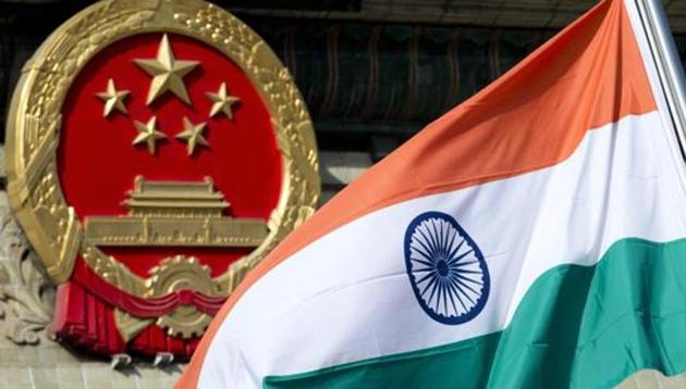 A file photo of an Indian flag next to the Chinese national emblem during a welcome ceremony for visiting Indian officials outside the Great Hall of the People in Beijing. India and China have been engaged in a month-long border standoff in the Doklam region located in the tri-junction of India, China and Bhutan.(AP)