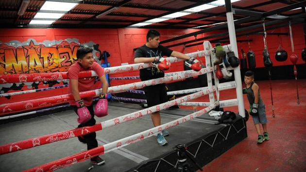 Two boys take a break in the ring during a training session at a popular gym in the outskirts of Mexico City. (Bernardo Montoya / AFP) Two boys take a break in the ring during a training session at a popular gym in the outskirts of Mexico City. (Bernardo Montoya / AFP)
